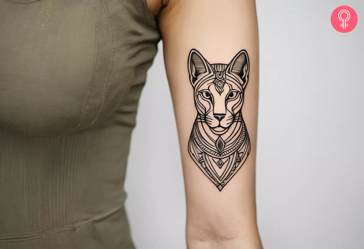 A graphic Bastet tattoo on the upper arm