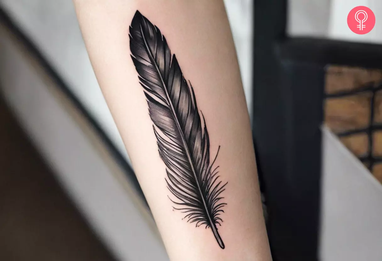 A hawk feather tattoo on the forearm