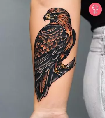 A woman with a vulture tattoo on the upper arm