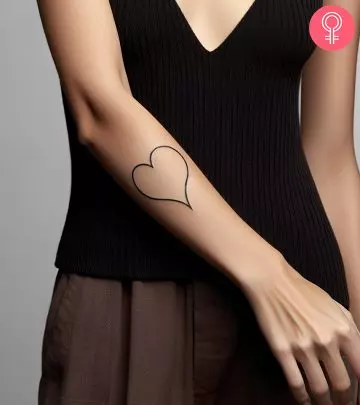 A sad girl tattoo on the upper arm