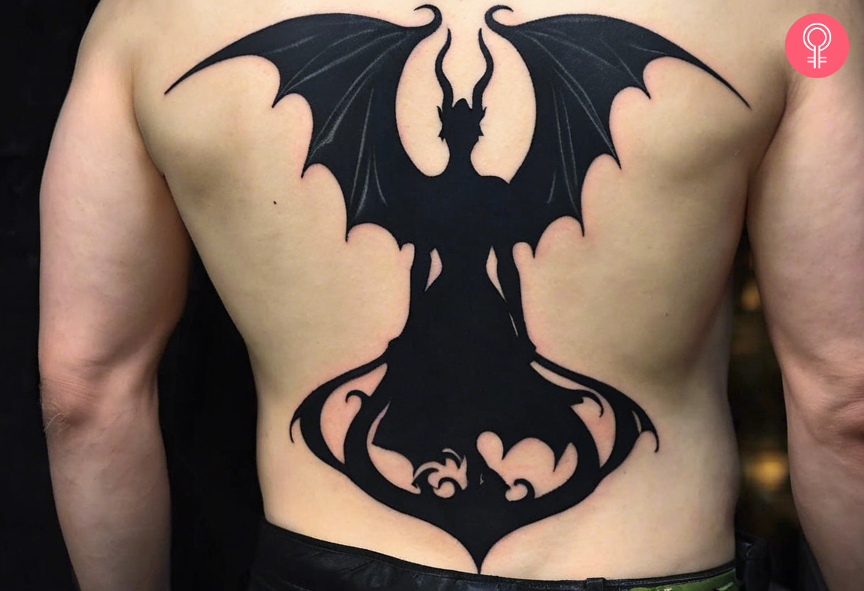 A man wearing a silhouette Maleficent tattoo at the back