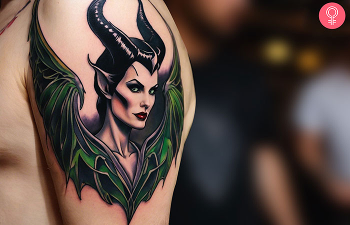 A man wearing maleficent wings tattoo on the upper arm