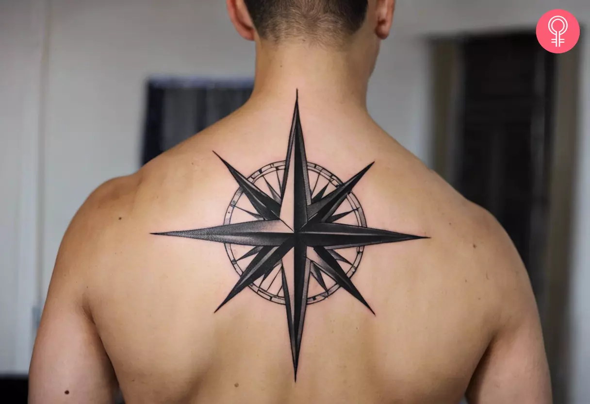 A man with a compass star tattoo at the back.