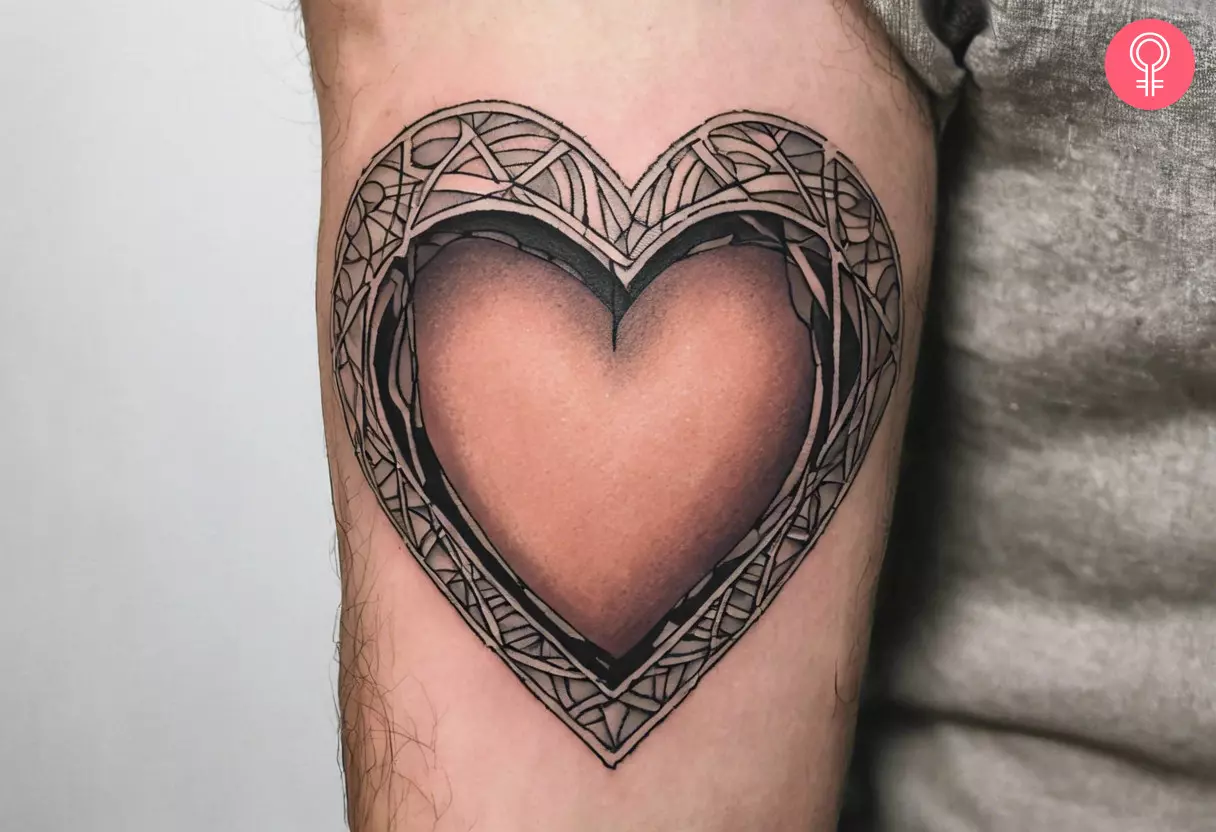 A man with a hollow heart tattoo on the upper arm