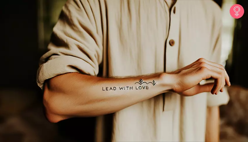 A man with a lead with love tattoo on the forearm