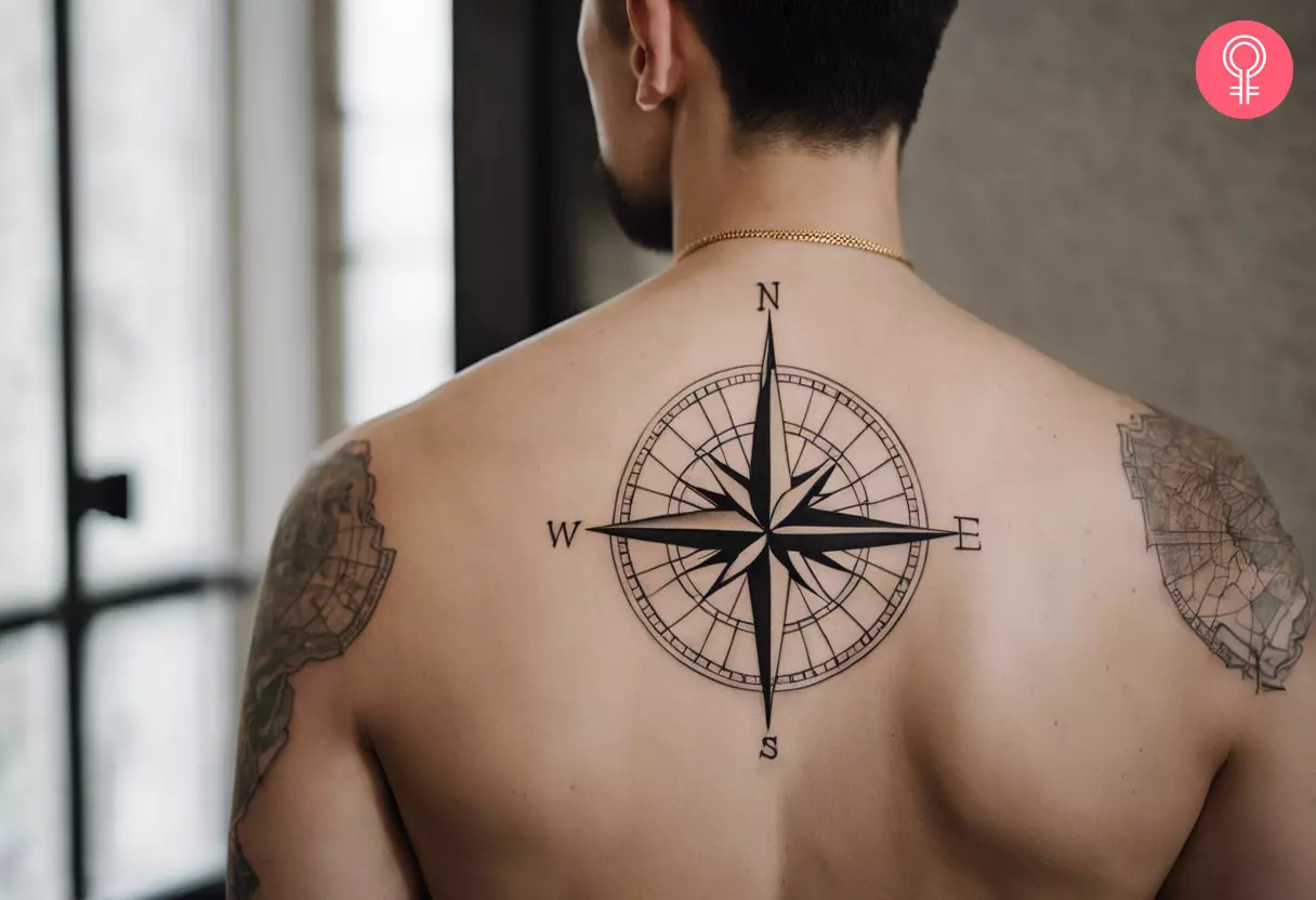 A man with a minimalistic compass tattoo on the upper back
