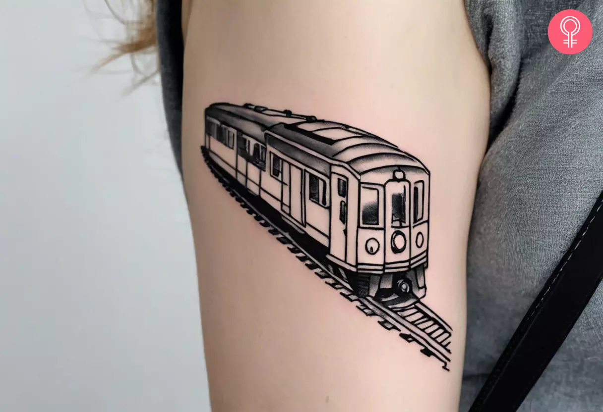 A minimalist train tattoo on the arm