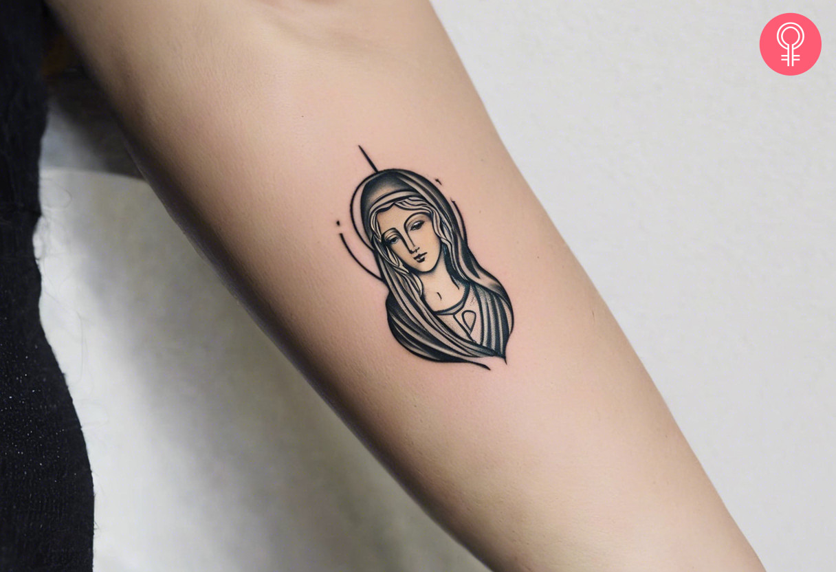 A minimalistic Mother Mary tattoo on the forearm