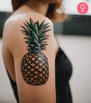 A pineapple tattoo on the upper arm