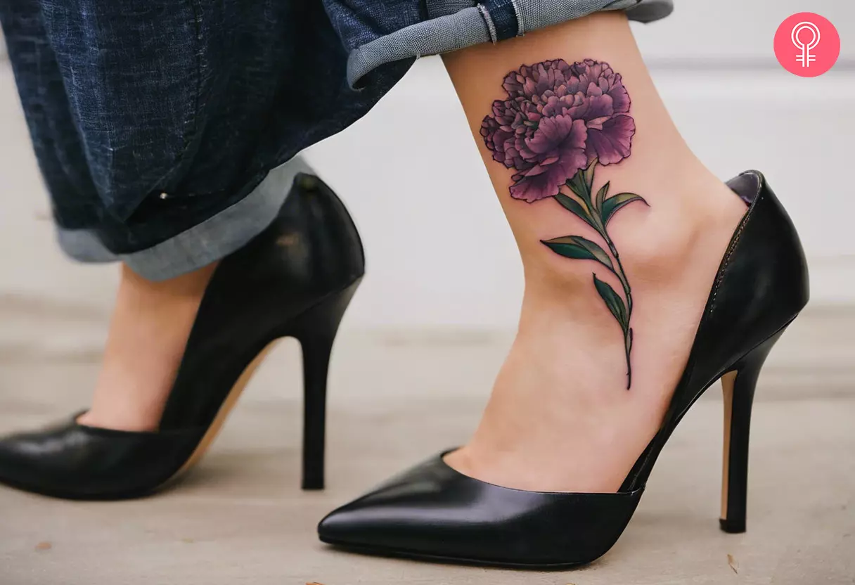 A purple carnation tattoo on a woman’s ankle