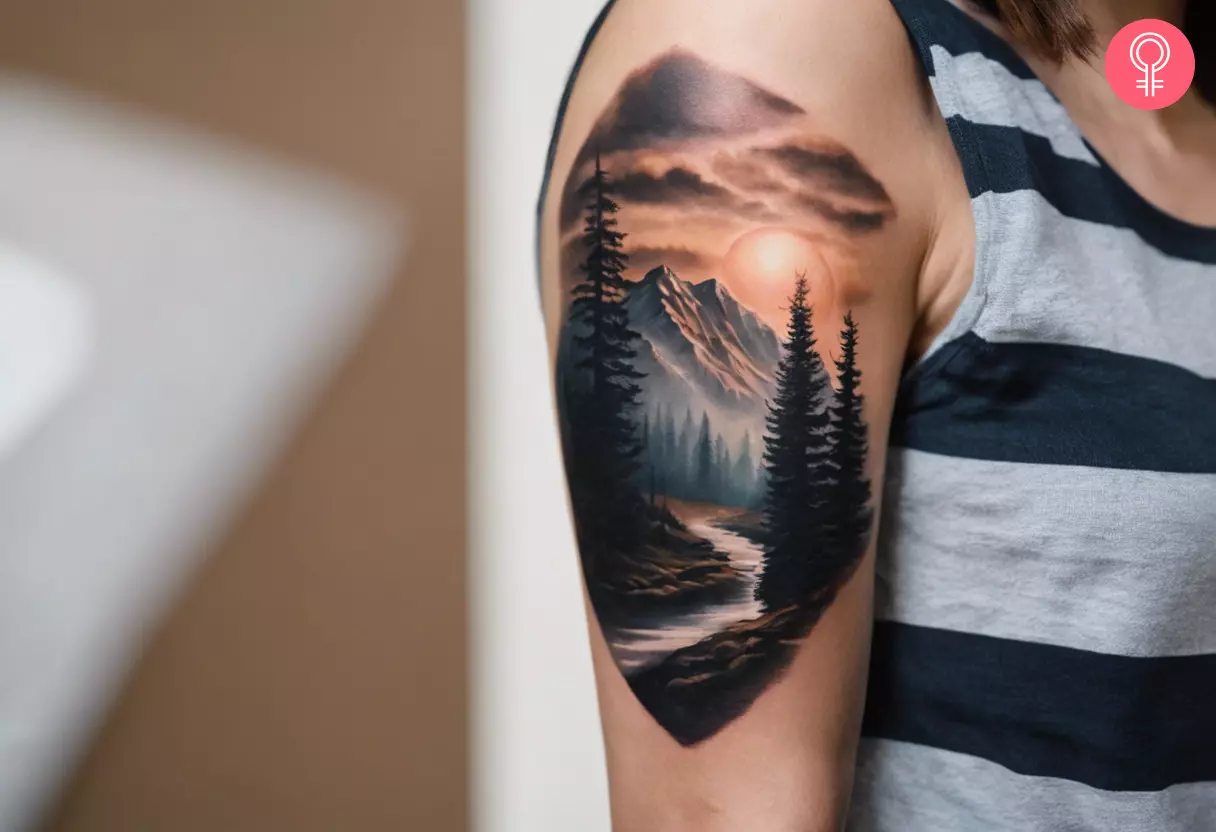 A realistic tattoo of a smokey mountain on the upper arm