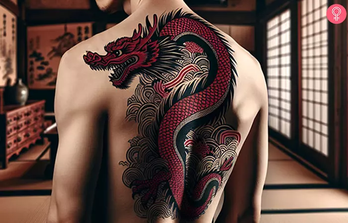 A red and black dragon tattoo on the back of a man