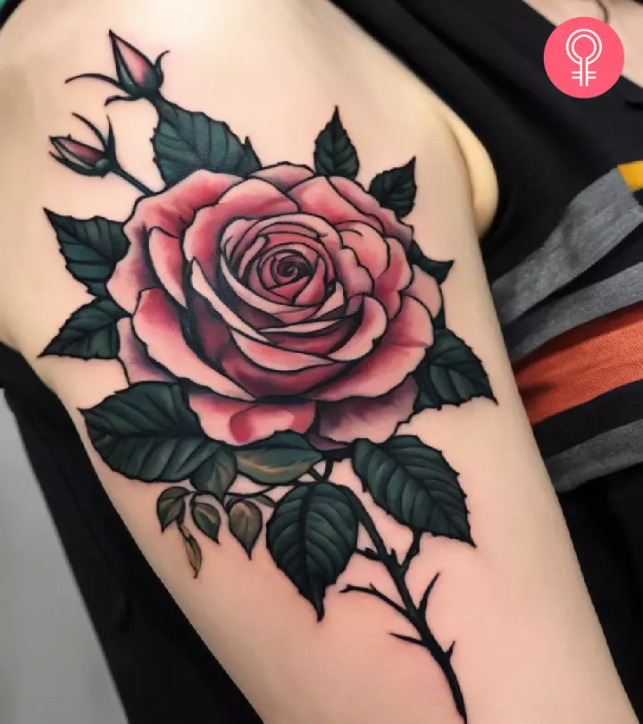 A rose with thorns tattoo on the upper arm
