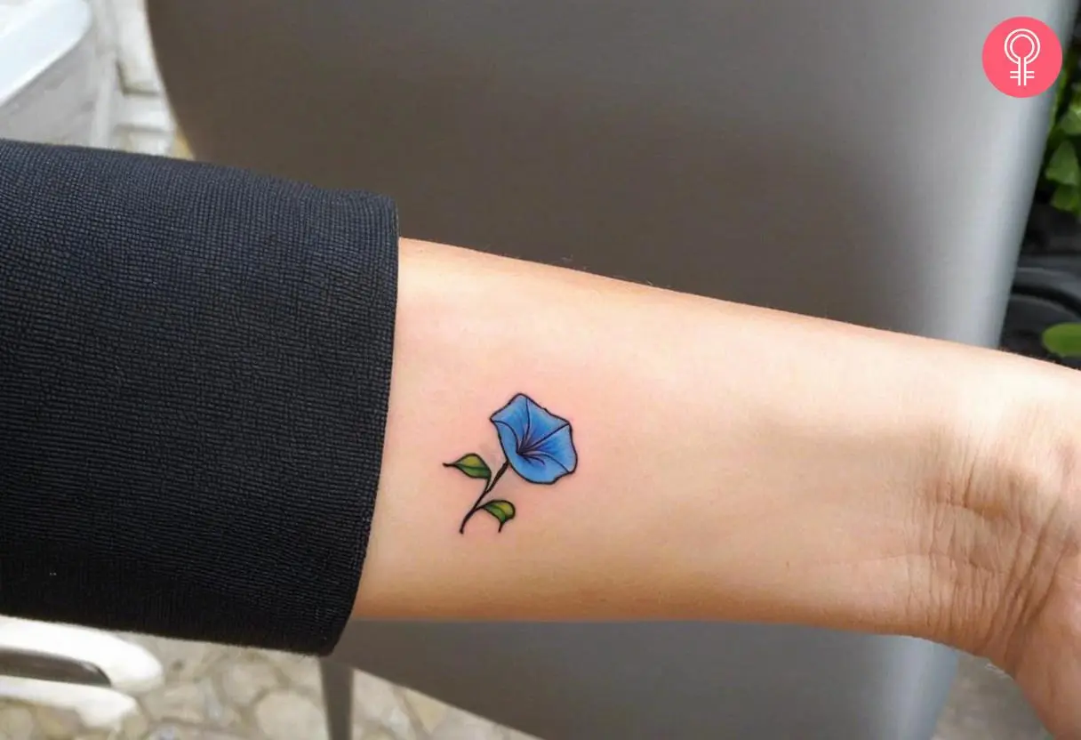 A simple morning glory tattoo on a woman’s wrist