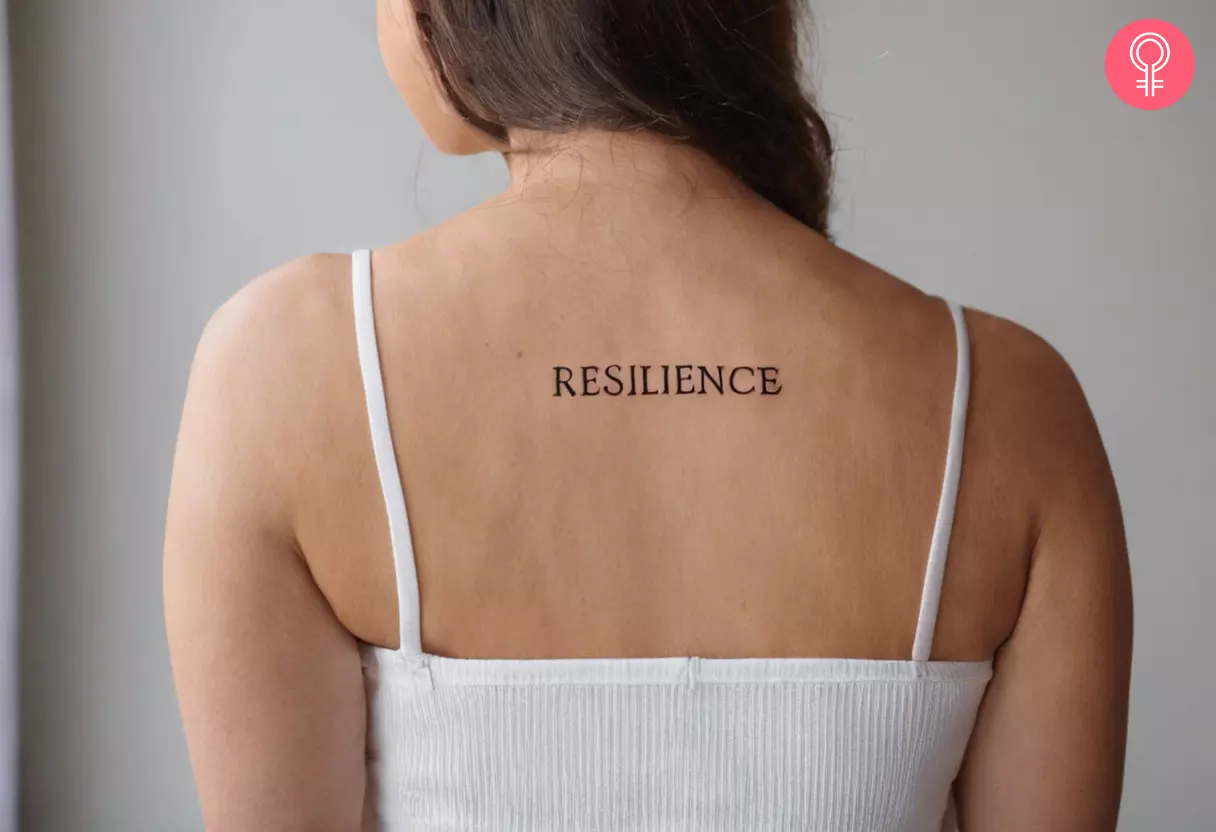 A simple script tattoo reading ‘resilience’