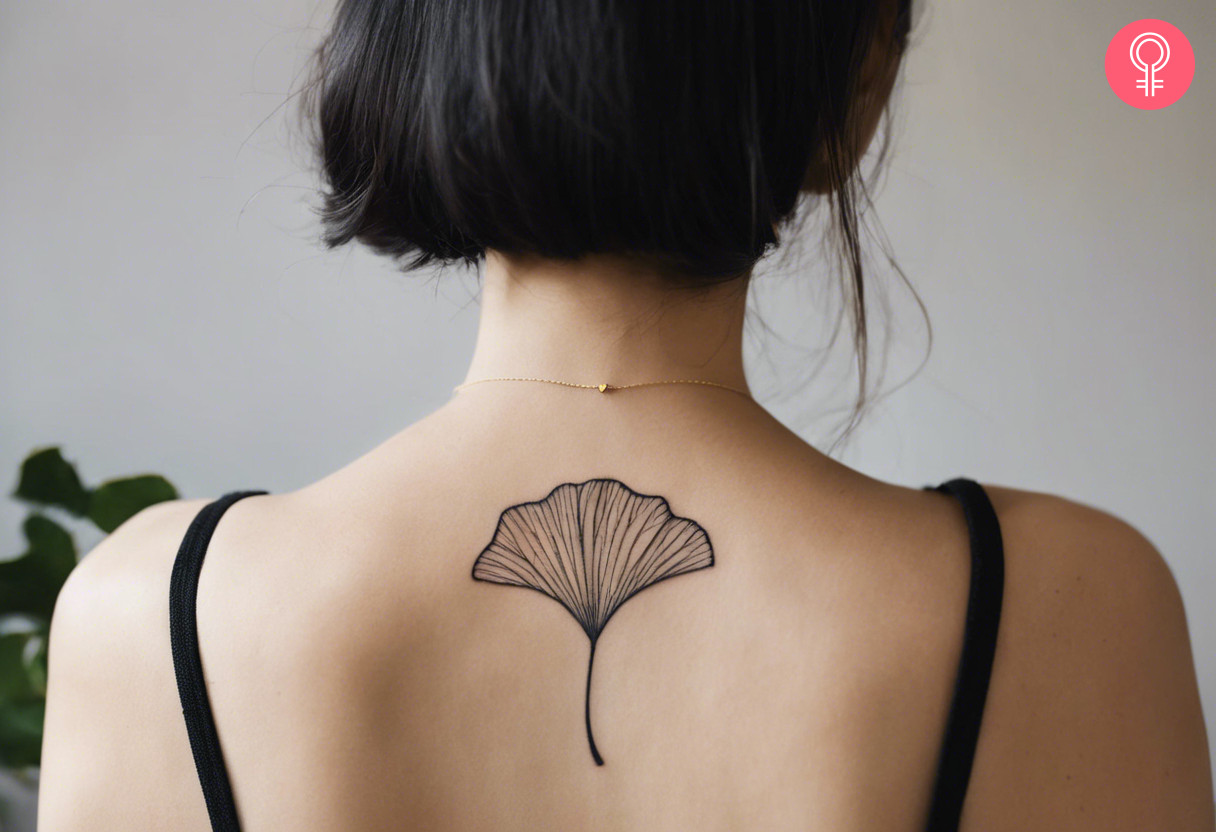 A single medium sized Ginkgo leaf tattoo on the upper back