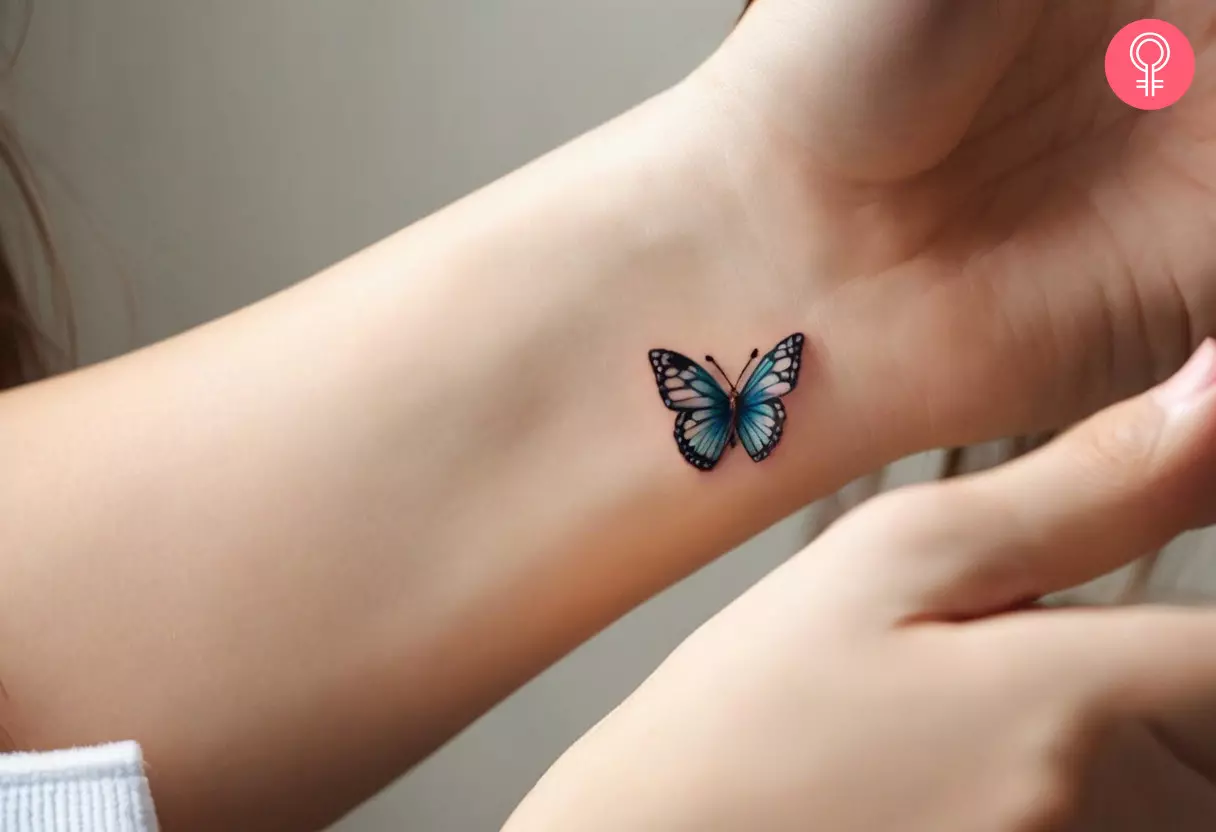 A small 3D butterfly tattoo on a woman’s wrist