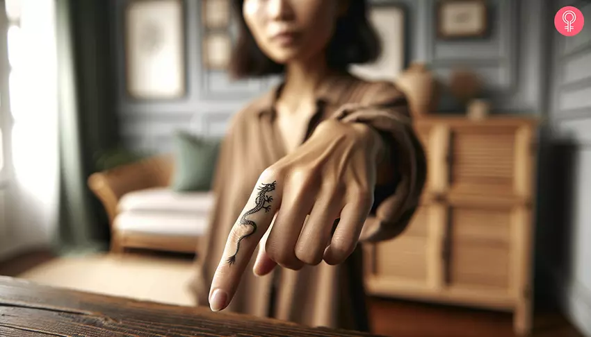 A small dragon tattoo on the index finger