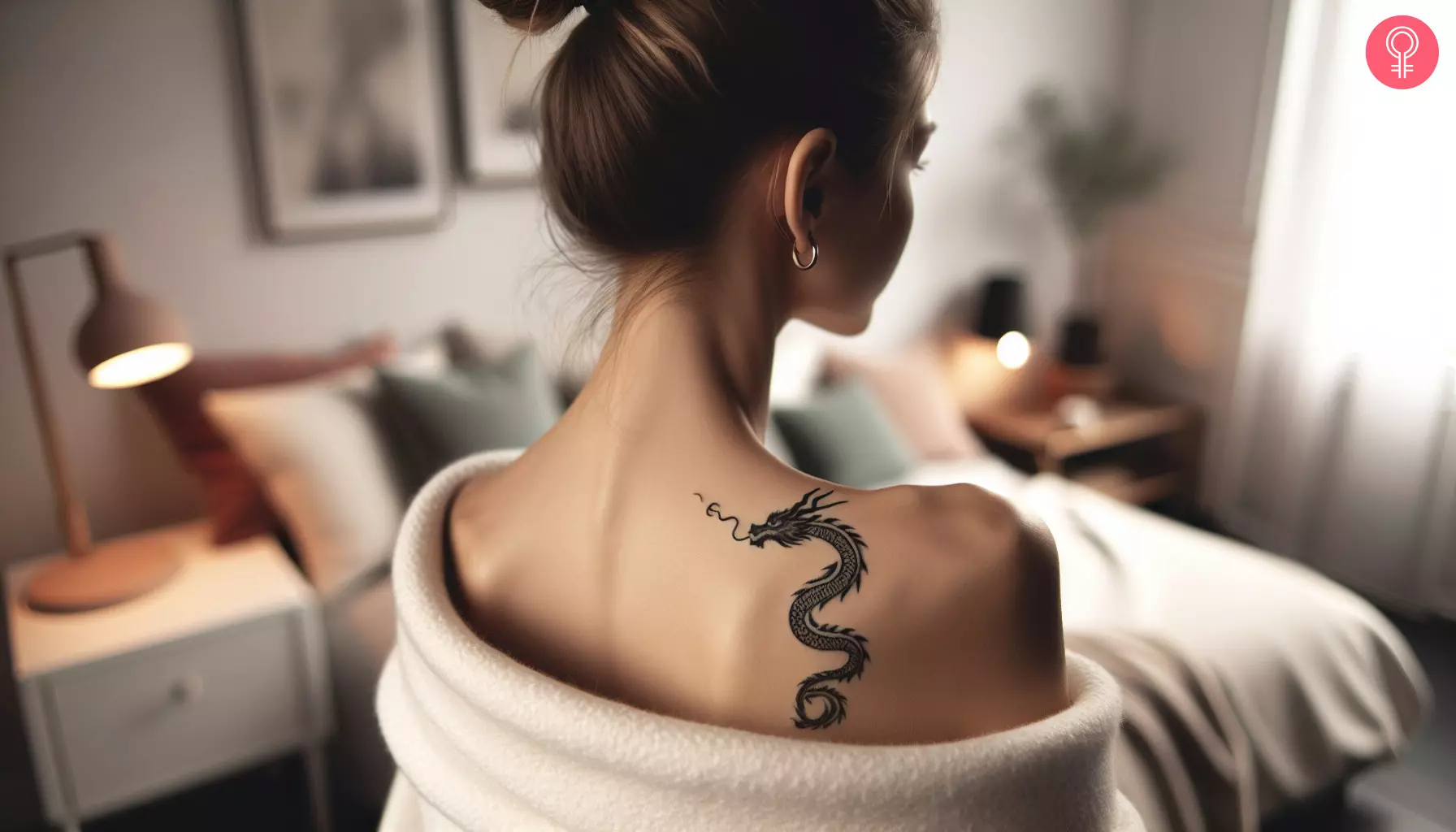 A small dragon tattoo on the shoulder of a woman