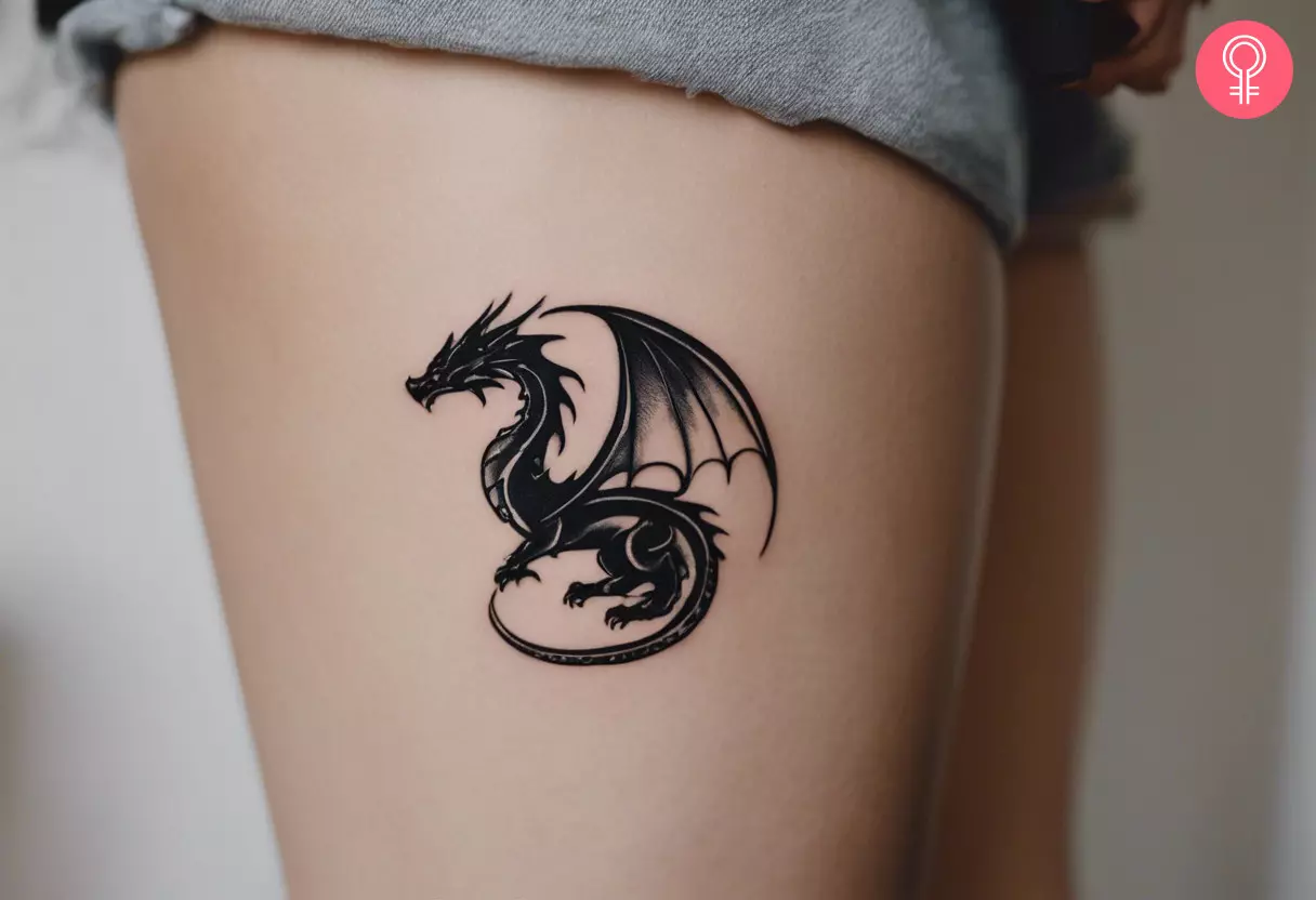 A small dragon tattoo on the side of the thigh of a woman