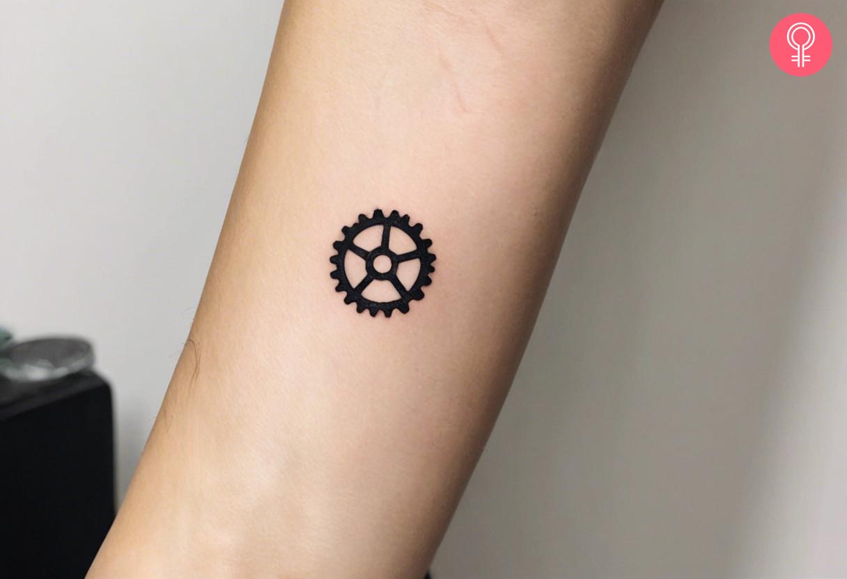 A small mechanic tattoo on the forearm