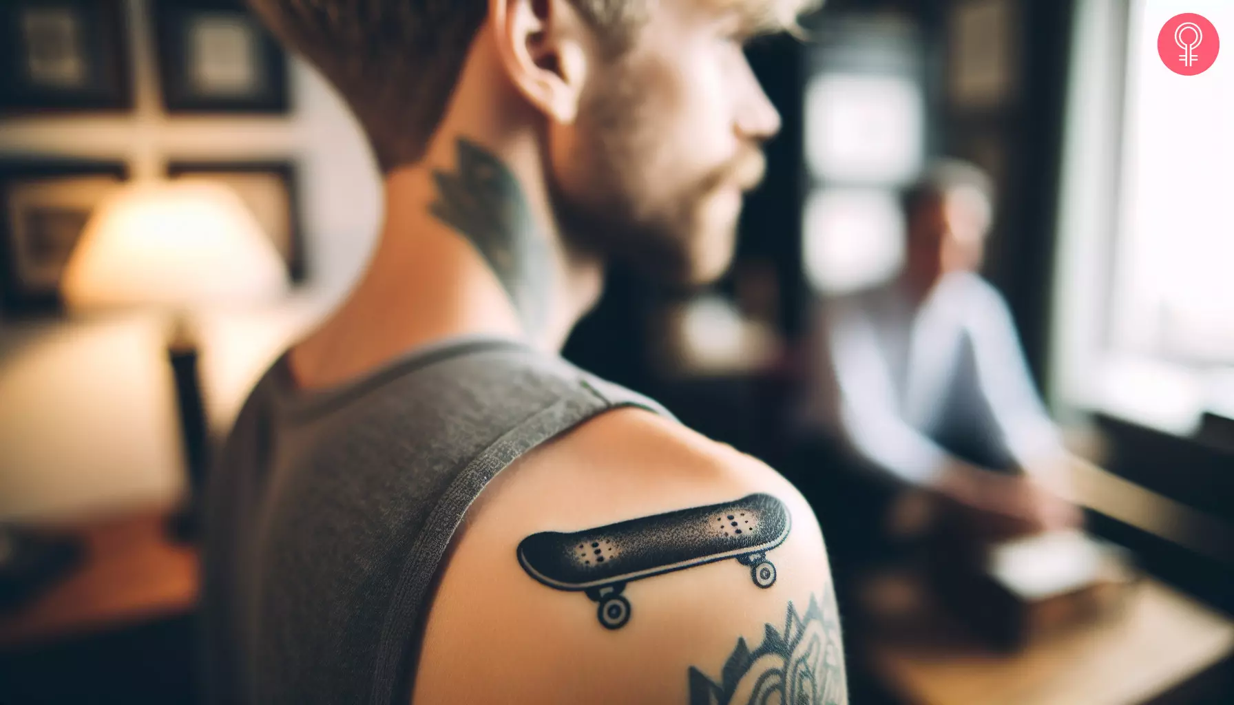 A small skateboard tattoo on the shoulder cuff