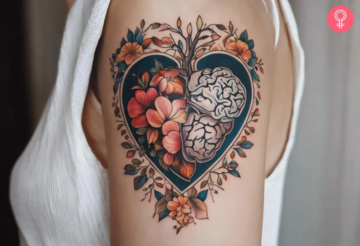 A tattoo on the upper arm showing brain and flowers