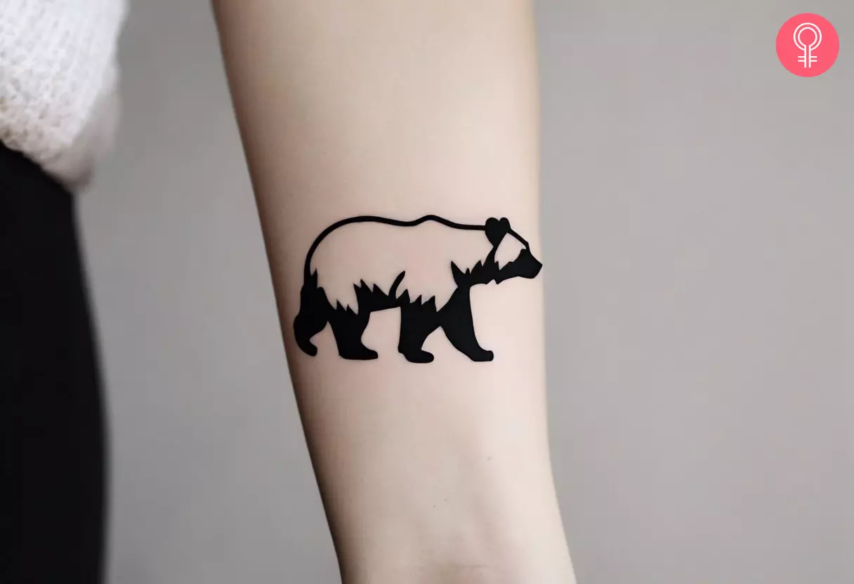 A traditional black bear tattoo on the forearm