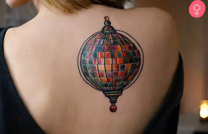 A traditional disco ball tattoo on the upper back