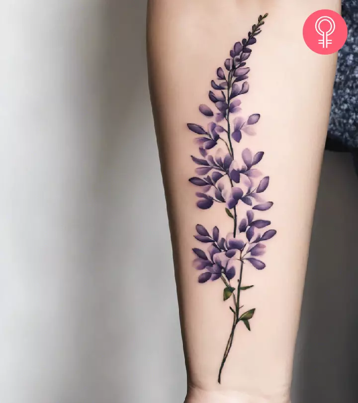 A wisteria tattoo on the arm of a woman