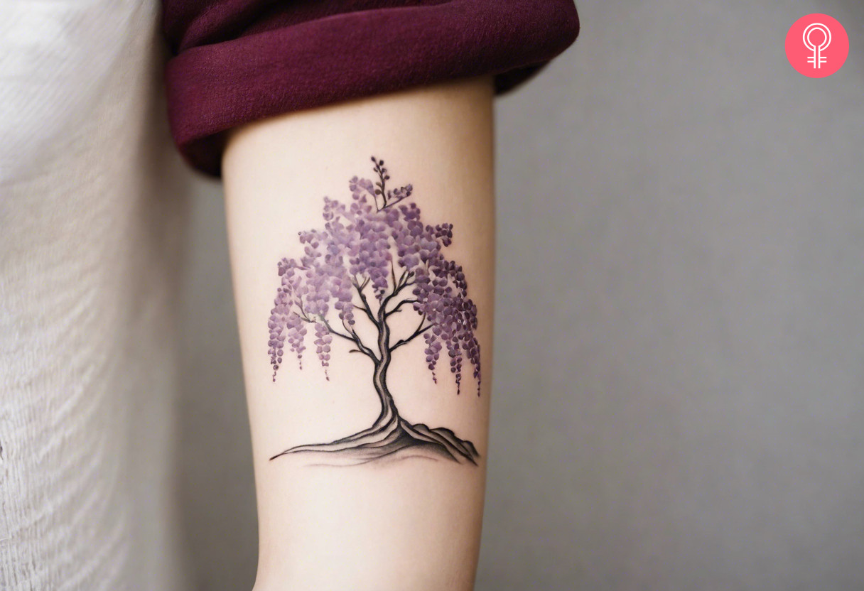 A wisteria tree tattoo on the arm of a woman