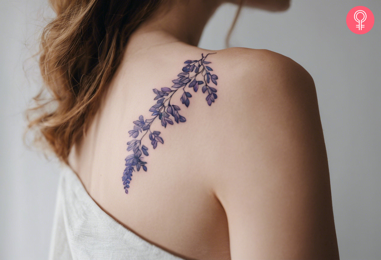 A wisteria vine tattoo on the shoulder of a woman