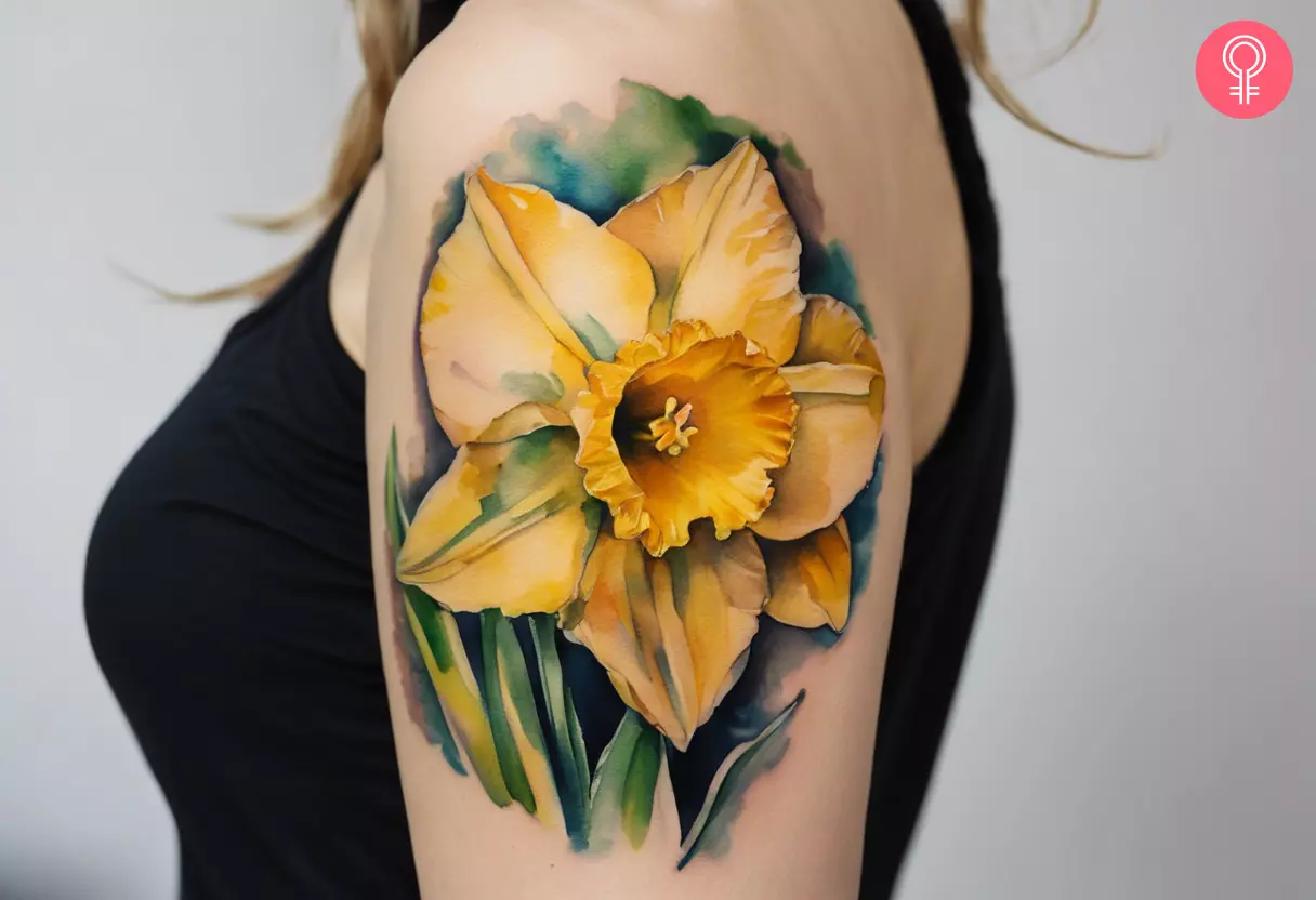 A woman flaunting a colored daffodil tattoo on her upper arm