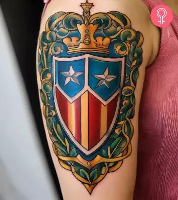 A woman flaunting a shield tattoo on the upper arm