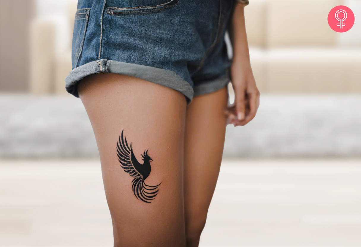 A woman wearing a phoenix thigh tattoo