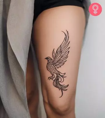 Woman with a phoenix tattoo on her thighs