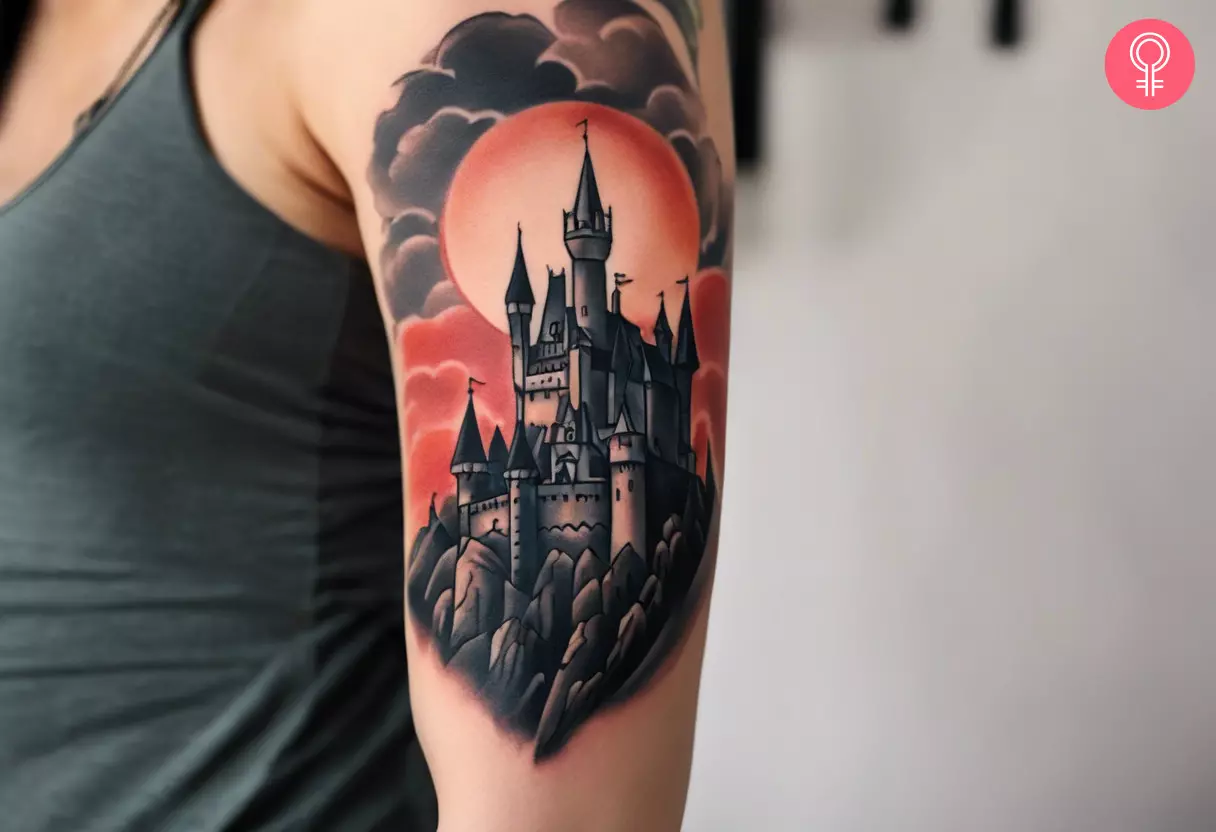 A woman with a Dracula castle tattoo on her upper arm