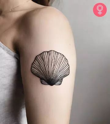 Wave and sun tattoo on the arm of a woman