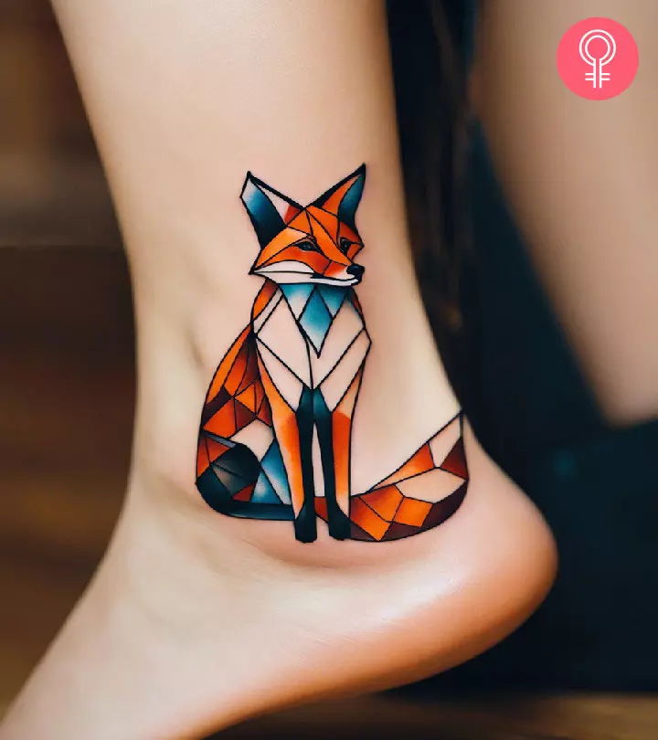 A woman with a colorful geometric fox tattoo on her leg