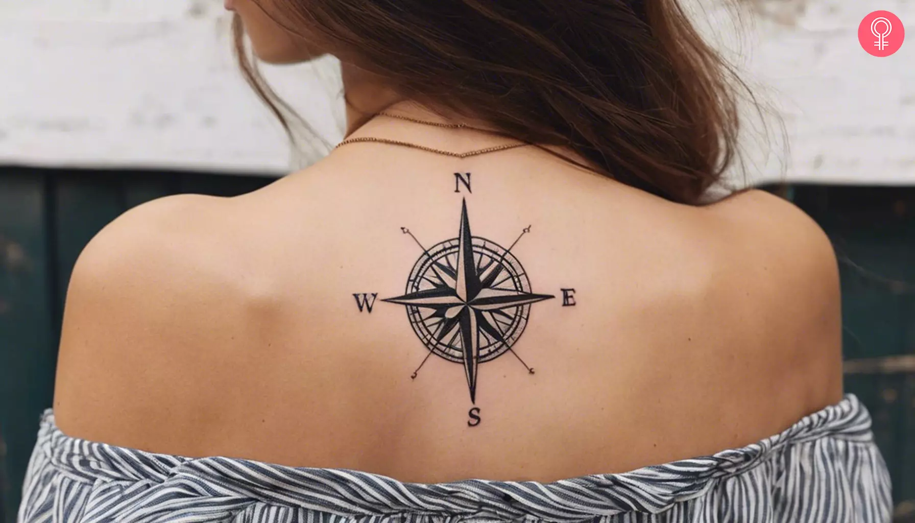 A woman with a compass back tattoo