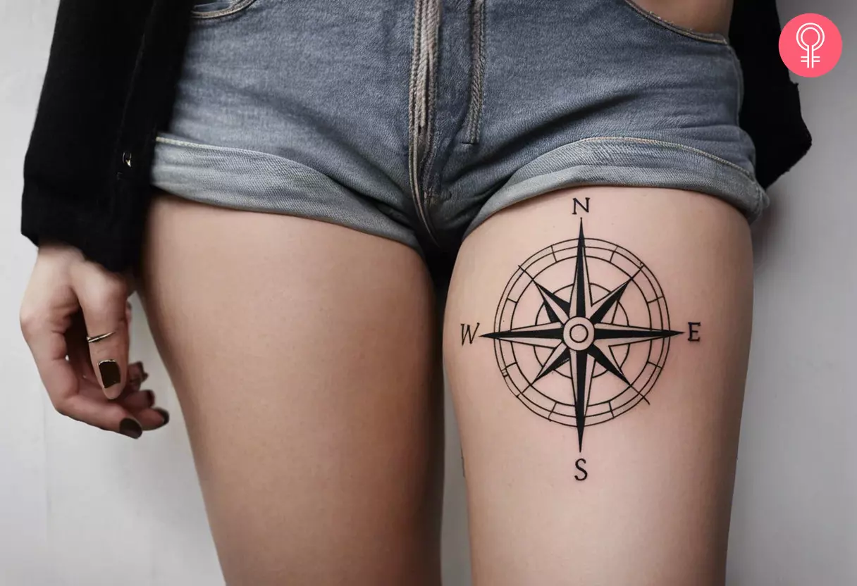 A woman with a compass thigh tattoo