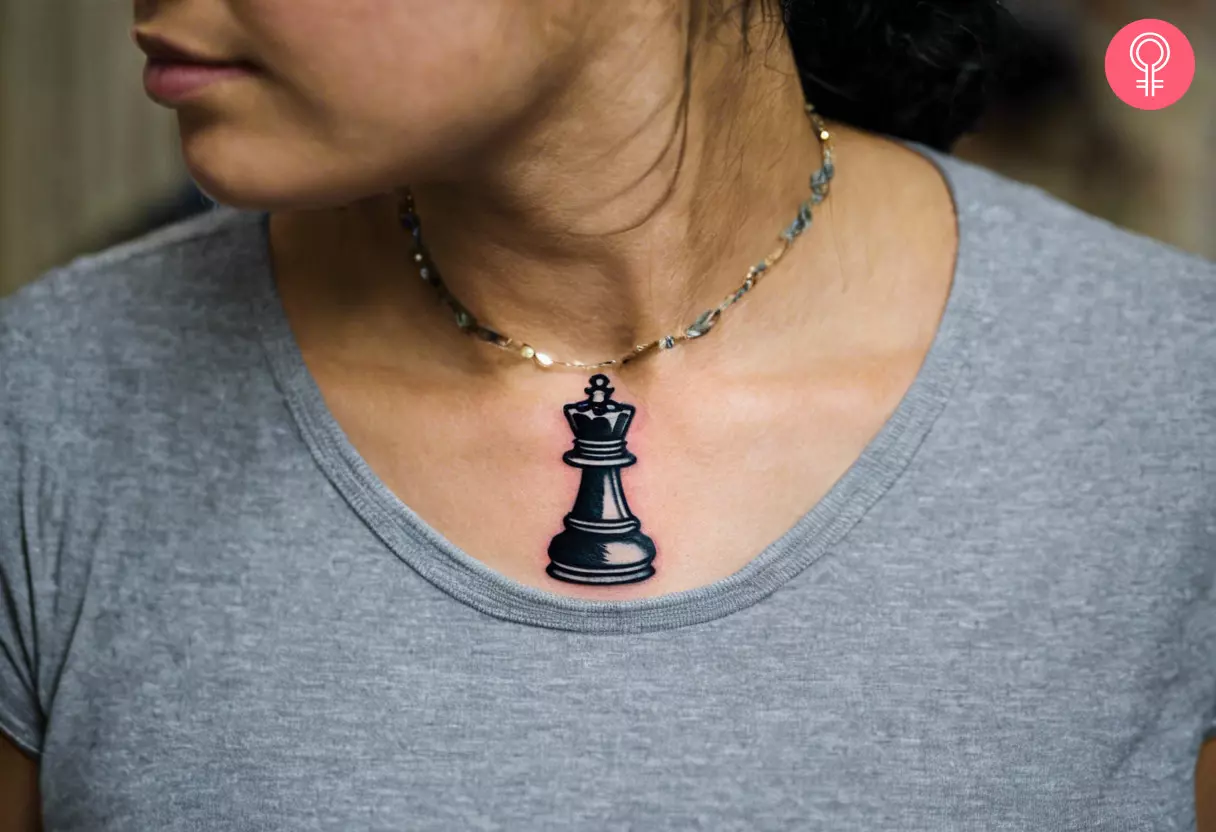 A woman with a queen chess piece tattoo on her chest