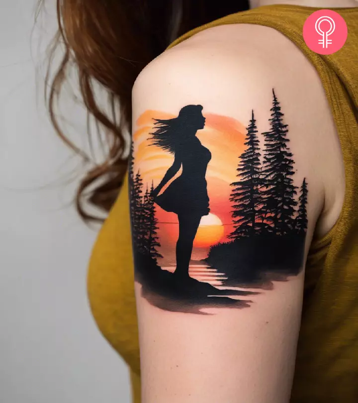 A woman with a silhouette tattoo of a girl enjoying a radiant sunrise