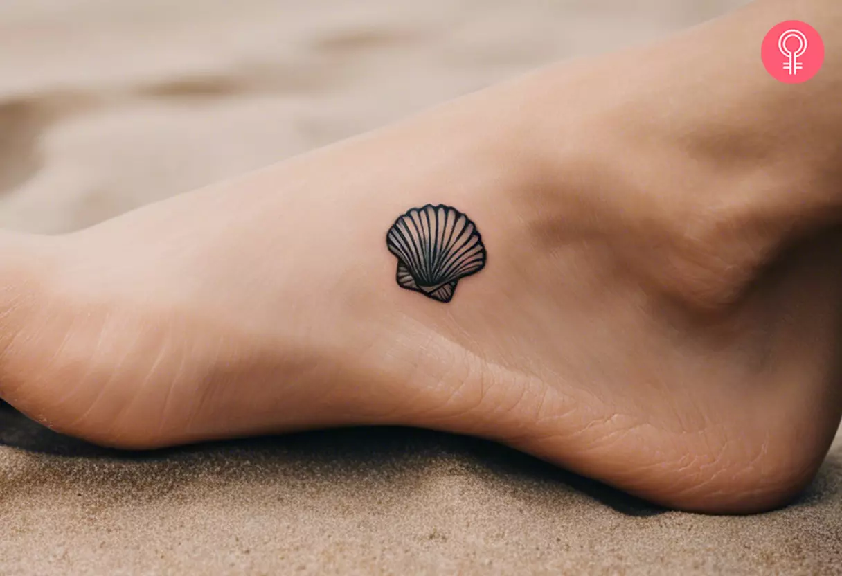 A woman with a small seashell tattoo on her foot