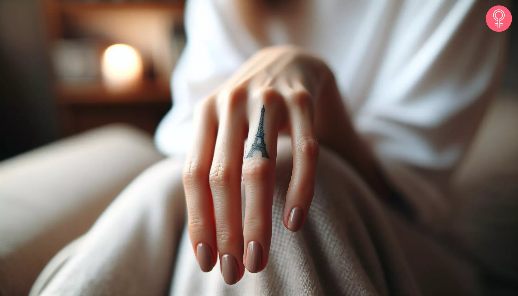 A woman with an Eiffel Tower tattoo on her finger