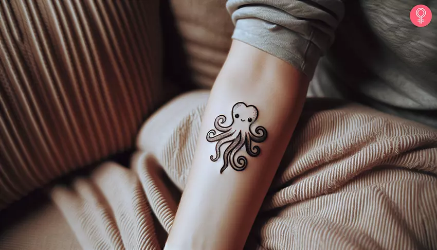 A woman with an octopus heart love tattoo on her lower arm