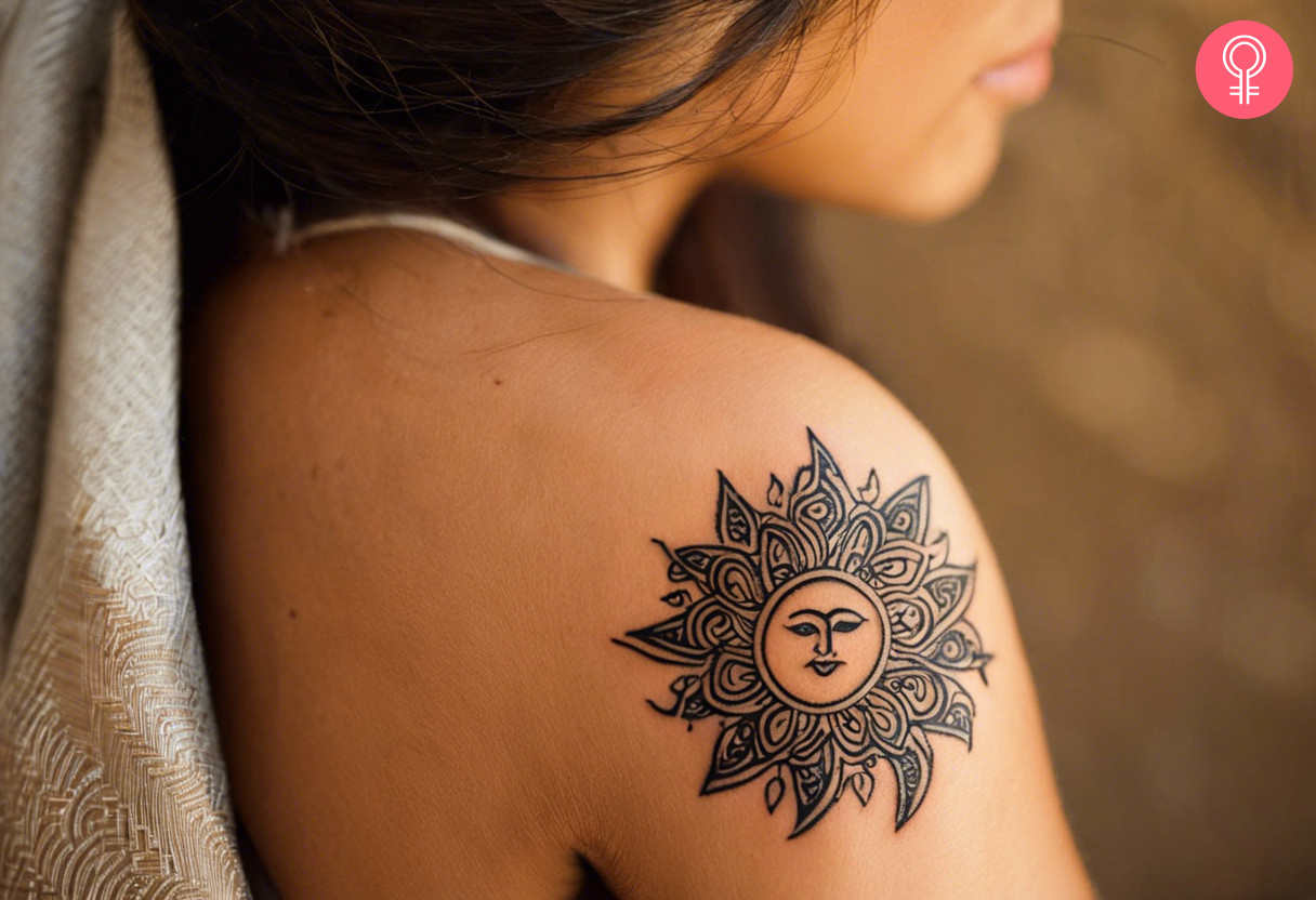 Aesthetic sun maori tattoo on the upper arm of a girl