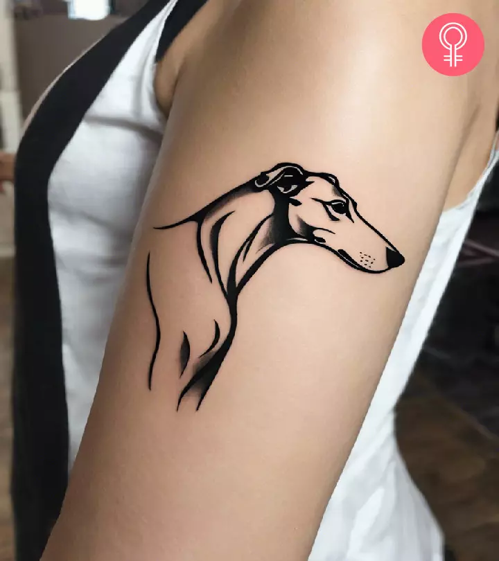 A woman sporting a greyhound tattoo