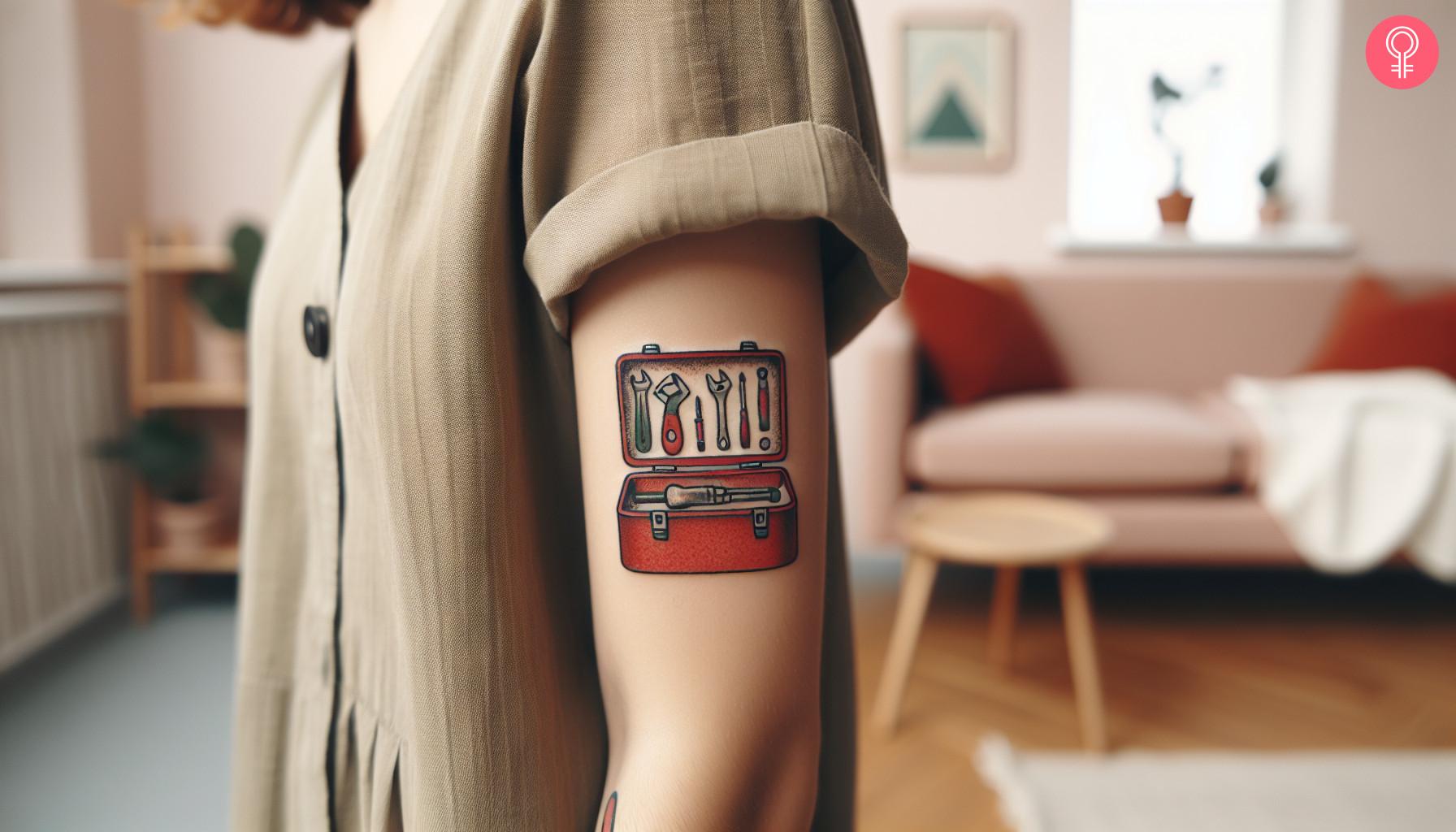 An old-school mechanic tattoo on a woman’s arm