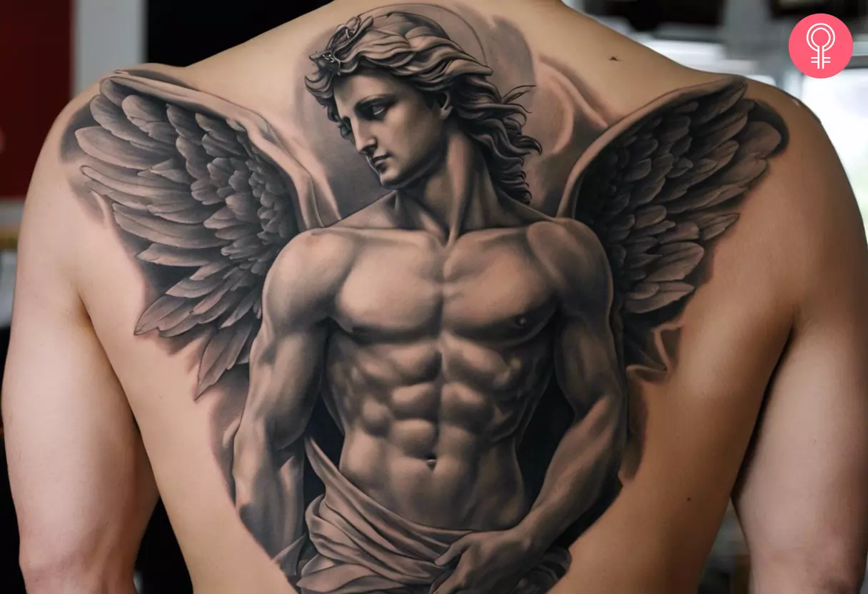 A man with an angel statue tattoo on the back